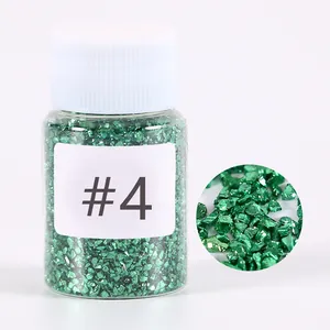 Detailed macro view of metallic green crushed glass stones for DIY resin crafts and art