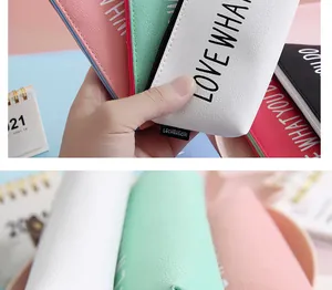 Detailed macro view showing the texture and pastel colors of these PU leather pencil cases