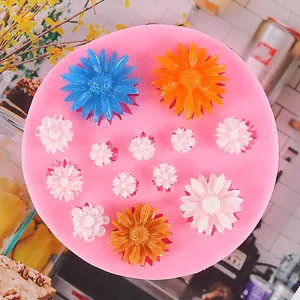Detailed close-up of a pink silicone mold featuring twelve varied daisy flower patterns