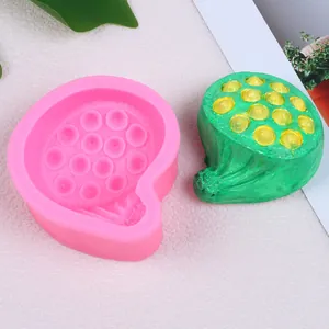 Detail of pink silicone lotus pod mold alongside a textured green finished product