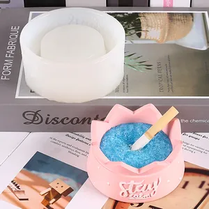 Detail view showing the silicone mold and a finished pink ashtray with blue filler.