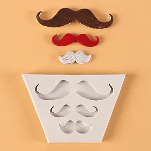 Detailed view of white silicone mold with finished mustache fondant pieces for cake