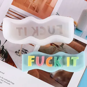 Detail view of a wavy silicone mold for DIY candles with colorful FUCK IT 3D letters