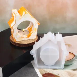 Detail showing house-shaped silicone mold and finished resin tea light candle holder.