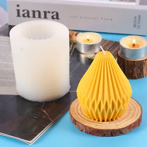 DIY geometric silicone candle mold featuring a finished yellow pleated scented candle on wood