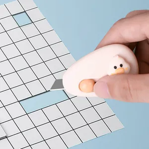 Cute cartoon chick mini utility knife for unboxing and paper cutting in lifestyle setting
