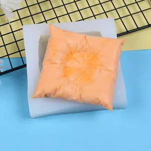 Close-up detail of 3D square pillow silicone mold with textured orange plaster finish