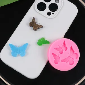 Pink butterfly silicone mold with colorful resin butterfly samples on a white phone