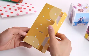 Handheld view showing folding mechanism of creative DIY jumping surprise gift box