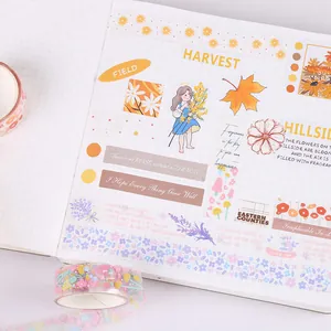 Macro view of transparent PET stickers with floral and harvest motifs on a journal page