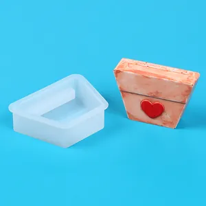 Macro view of silicone mold and finished trapezoid flower pot with red heart detail