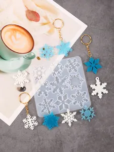 Detailed view of DIY silicone snowflake mold with colorful finished resin pendants