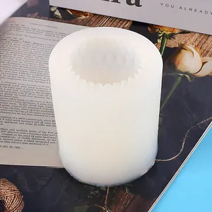 Close-up of a cylindrical silicone mold with a faceted internal texture for DIY candles