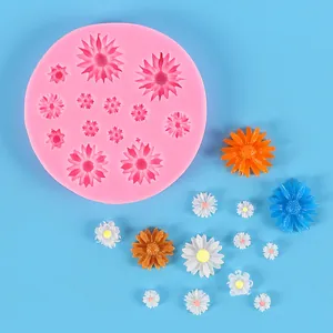 Detailed view of a pink daisy silicone mold with various finished colorful resin flowers