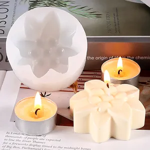 Macro detail view of a white flower-shaped silicone mold for DIY candles and artisanal soaps.