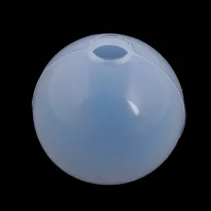 Detailed macro shot of a translucent spherical silicone mold used for DIY resin casting projects