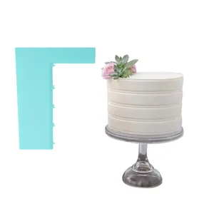 Light blue serrated cake scraper shown with a decorated white layered cake