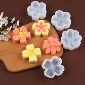 Detailed view of cherry blossom and clover silicone molds with finished floral cakes