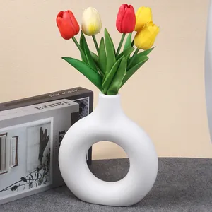 Minimalist white donut plastic vase with colorful artificial tulips decoration