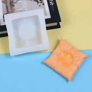Detailed view of square pillow silicone mold with a finished orange squishy sample