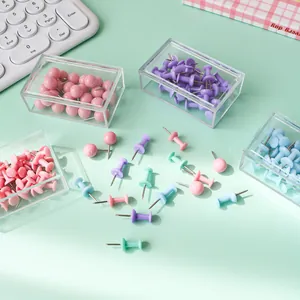 Assorted macaron colored push pins set in clear storage boxes for office and DIY decor.
