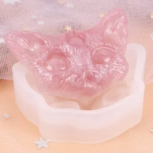 Gedetailleerd overzicht van een siliconen mal voor een drie-ogige kattenkop met roze harsgieting.