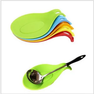 Close-up detail of colorful heat resistant silicone spoon rests and kitchen ladle usage