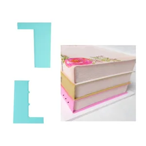 Detail showing mint green cake scrapers used for creating realistic book page textures