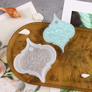 Arabesque shaped silicone mold and light blue resin pendant with crystal texture