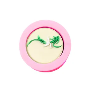 Circular pink silicone mold with floral design for DIY cake decorating and soap making