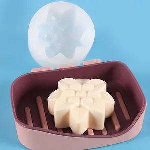 Detail view of chrysanthemum flower silicone mold and finished cream-colored soap