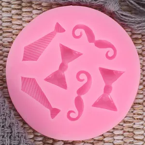 Detailed view of pink silicone mold with mustache and tie shapes for cake decorating