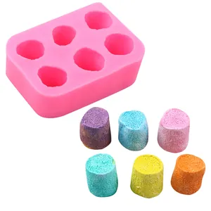 Detail view of 6-cavity pink silicone mold with colorful marshmallow-shaped crafts.