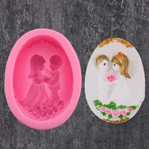 Pink bride and groom silicone mold with finished white fondant cake decoration