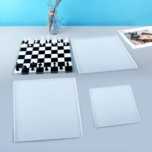 Detailed view of DIY chessboard resin molds featuring a finished black and white sample