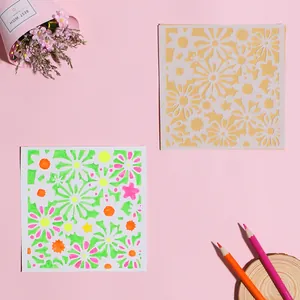 Detailed view of hollow floral painting stencil and finished colorful DIY artwork.