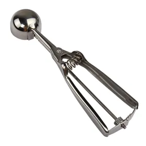 Macro view of stainless steel ice cream scoop with ergonomic trigger handle mechanism
