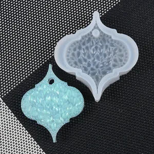 Close-up detail of translucent silicone resin mold with finished blue glitter pendant