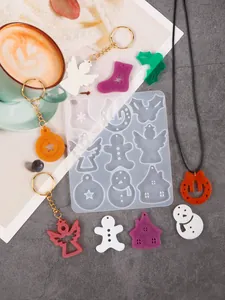 Detailed macro view of a Christmas-themed silicone mold for DIY resin pendants and keychains