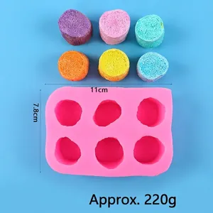 Detail of 6-cavity pink silicone mold for DIY marshmallow shapes with colorful samples