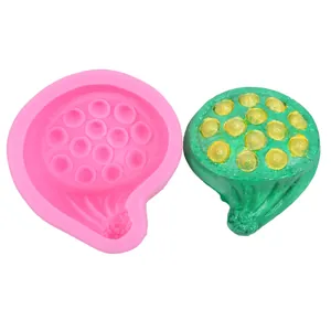 Detail showing pink lotus pod silicone mold alongside green finished textured replica