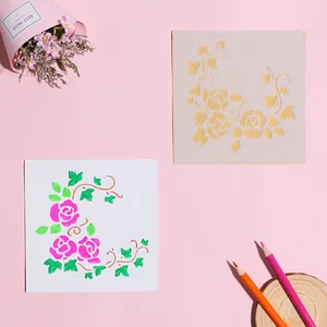 Close-up of DIY hollow flower painting stencil with pink rose and green leaf artistic results