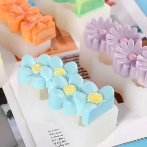 Detailed view of flower-shaped silicone molds for DIY soap and aromatherapy candle making.