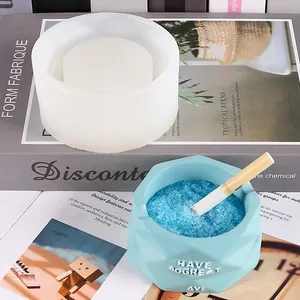 DIY silicone ashtray mold with finished geometric resin sample on decorative books