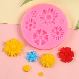 Detailed view of pink silicone flower mold with multi-colored floral fondant samples