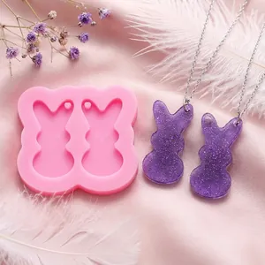 Detailed view of double rabbit silicone mold with purple glitter resin DIY pendants