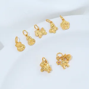 Macro-detail van diverse 24K vergulde DIY-sieradenbedeltjes inclusief vlinder en kalebas.
