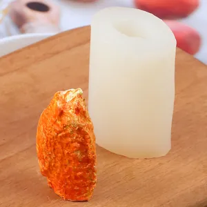 Detailed macro view of the silicone mold and a realistic faux chicken wing model.
