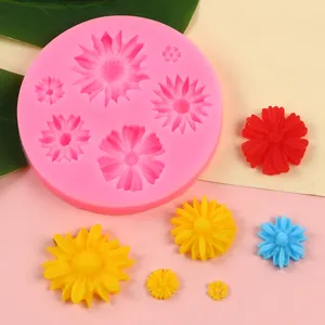 Macro view of pink sunflower silicone mold showing colorful DIY fondant flower samples