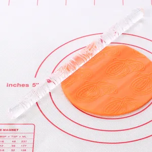 Transparent acrylic rolling pin with floral pattern for DIY fondant cake decorating.